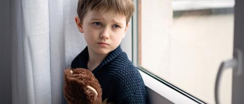 Young Boy Hugging Teddy Bear with Depression